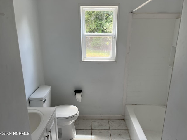 bathroom featuring toilet, vanity, baseboards, marble finish floor, and shower / washtub combination