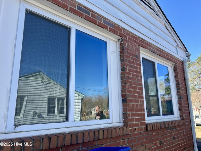 view of property exterior with brick siding