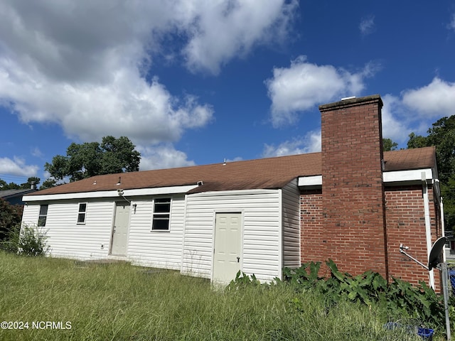 back of property featuring a chimney