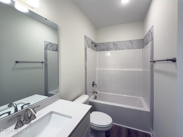 full bathroom featuring vanity, bathtub / shower combination, and toilet