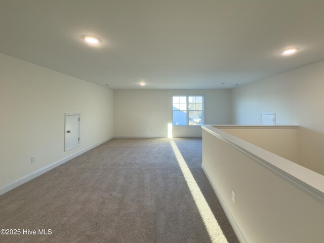 walk in closet with dark colored carpet