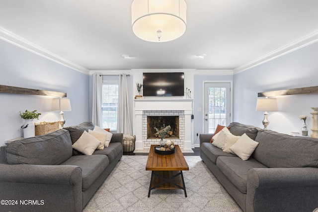 carpeted living room featuring a brick fireplace and ornamental molding