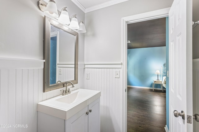 bathroom featuring wood-type flooring, vanity, and crown molding