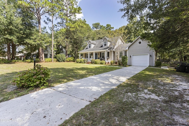 new england style home featuring a front lawn, a porch, and a garage