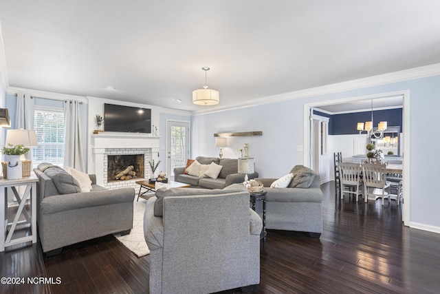 living room featuring a fireplace, dark wood-type flooring, crown molding, and a healthy amount of sunlight