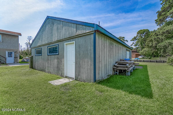 view of outdoor structure with a lawn