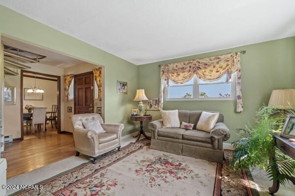 living room featuring hardwood / wood-style floors and an inviting chandelier