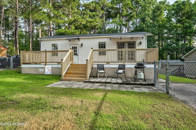 back of house featuring stairway, a gate, fence, a deck, and a yard