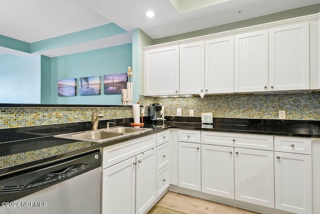 kitchen with dishwasher, light hardwood / wood-style flooring, and backsplash