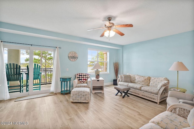 living room featuring light hardwood / wood-style flooring and ceiling fan