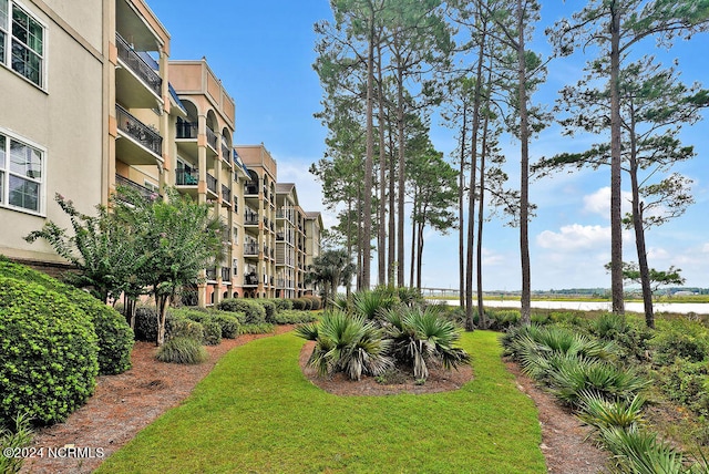 view of property's community with a lawn