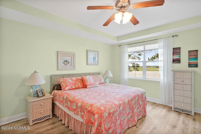 bedroom with ceiling fan and light hardwood / wood-style floors