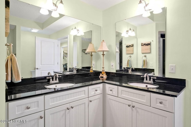 bathroom with a tray ceiling and vanity