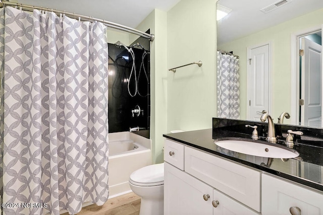 full bathroom with vanity, toilet, hardwood / wood-style floors, and shower / bath combo with shower curtain