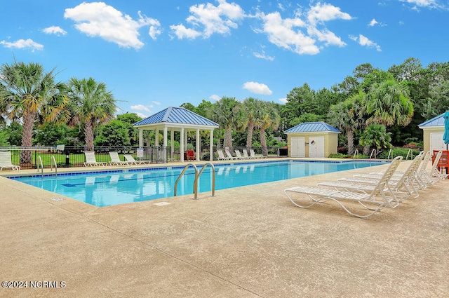 view of pool with an outdoor structure, a patio, and a gazebo