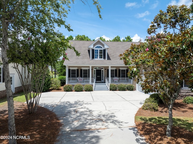 cape cod-style house with a porch and a garage