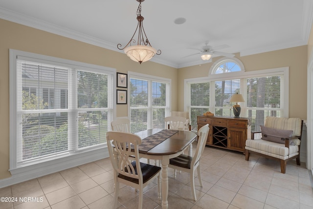 dining space with light tile patterned floors, ornamental molding, and a ceiling fan