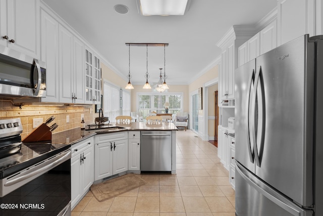 kitchen featuring a sink, white cabinets, appliances with stainless steel finishes, dark countertops, and glass insert cabinets