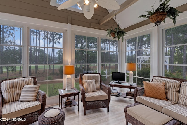 sunroom with vaulted ceiling with beams, ceiling fan, and plenty of natural light