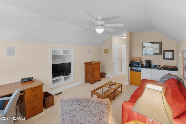 living area with built in features, baseboards, light colored carpet, ceiling fan, and vaulted ceiling