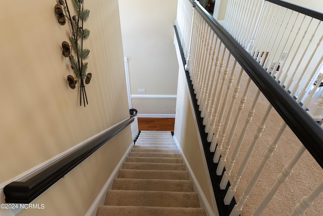 staircase featuring baseboards