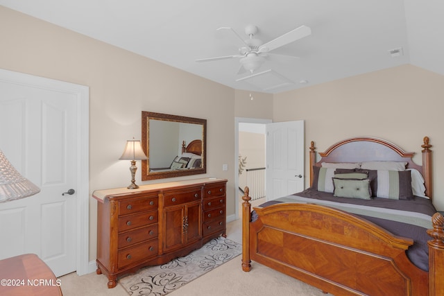 bedroom featuring ceiling fan, visible vents, vaulted ceiling, and light colored carpet