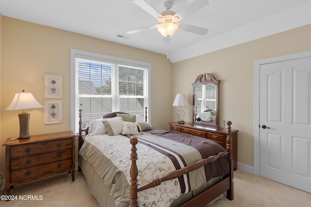 bedroom with lofted ceiling, visible vents, a ceiling fan, light carpet, and baseboards