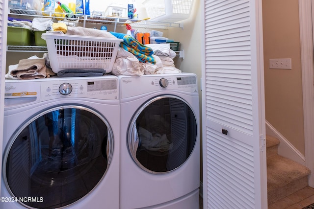 clothes washing area featuring laundry area, baseboards, and separate washer and dryer