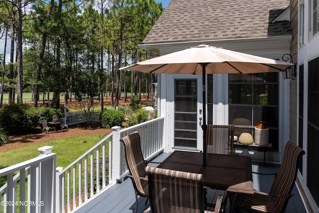 deck featuring fence and a lawn