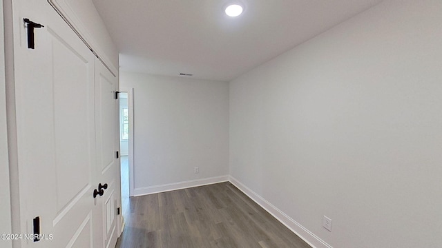 hall with wood finished floors and baseboards