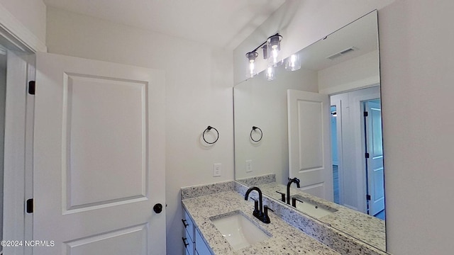 bathroom featuring vanity and visible vents