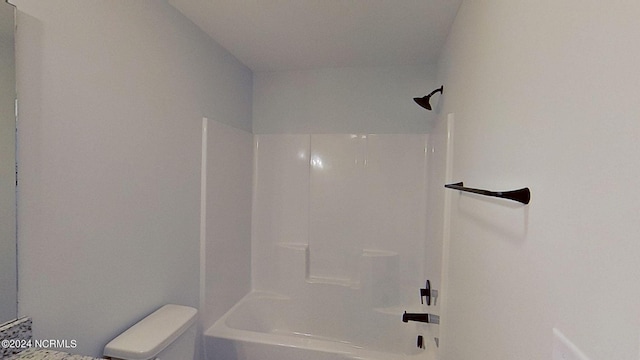 bathroom featuring shower / washtub combination and toilet