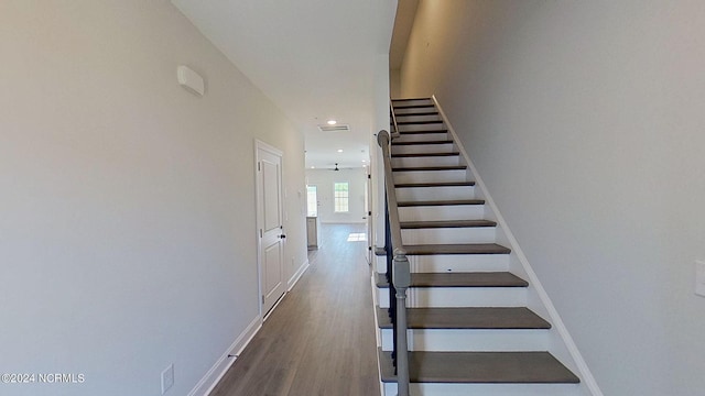 stairway featuring recessed lighting, baseboards, and wood finished floors