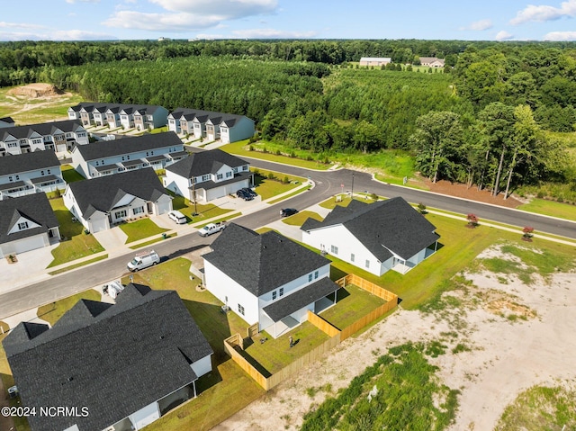 aerial view featuring a forest view and a residential view