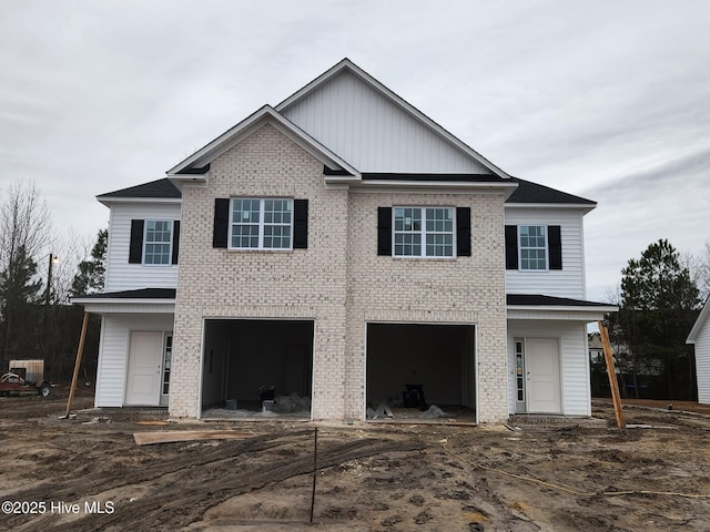 view of front of house with a garage and brick siding