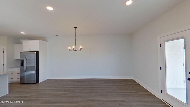 interior space featuring baseboards, a chandelier, dark wood finished floors, and recessed lighting