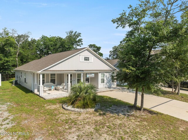 view of front of house with a porch and a front yard