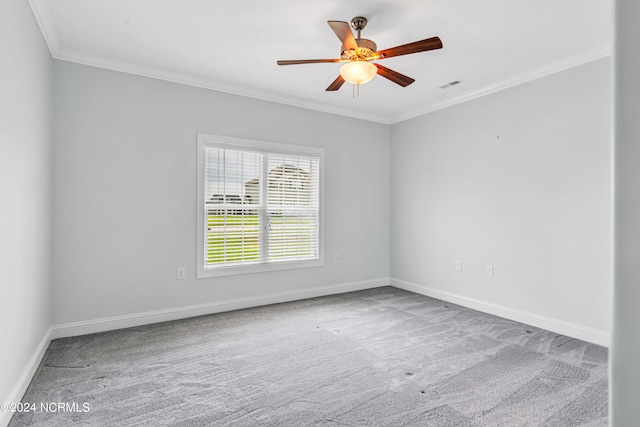 carpeted spare room featuring ceiling fan and crown molding