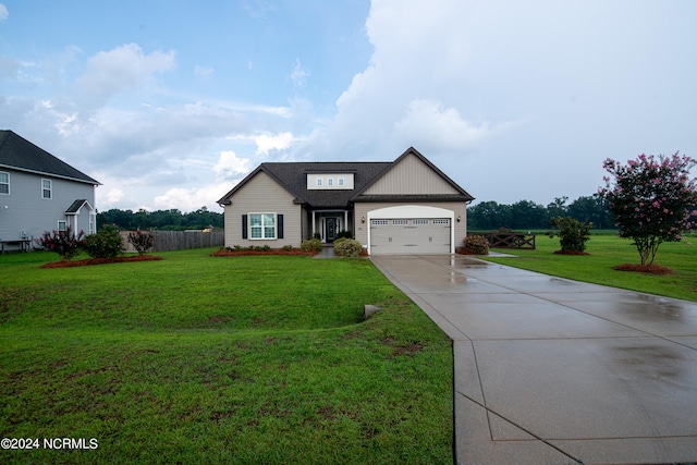 view of front of home featuring a front lawn and a garage