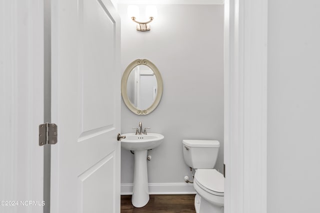 bathroom with toilet and hardwood / wood-style flooring