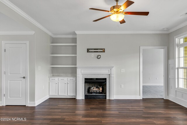 unfurnished living room featuring ceiling fan, a fireplace, hardwood / wood-style floors, and crown molding