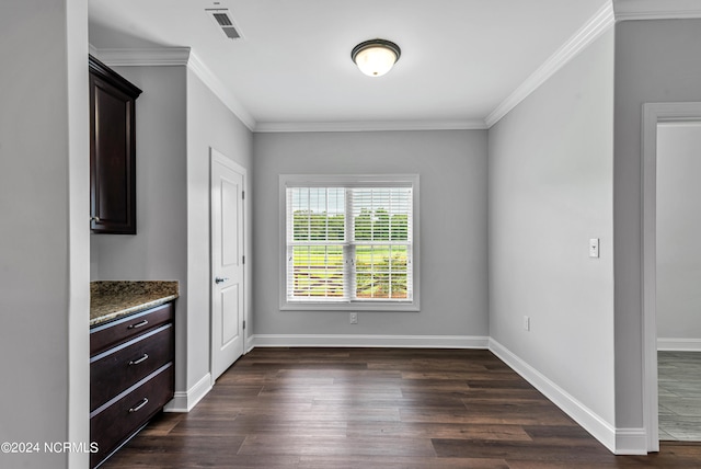 unfurnished dining area with dark hardwood / wood-style flooring and ornamental molding