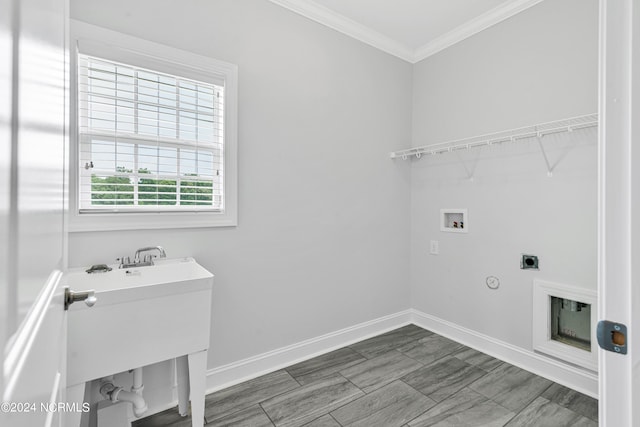 clothes washing area featuring hookup for a washing machine, crown molding, gas dryer hookup, and electric dryer hookup