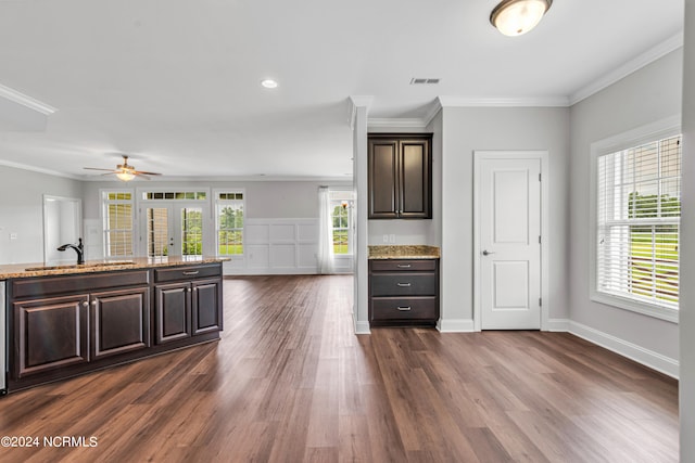 interior space featuring dark brown cabinets, sink, dark hardwood / wood-style flooring, and ornamental molding