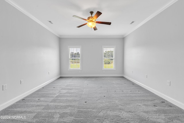 carpeted spare room with ceiling fan and crown molding