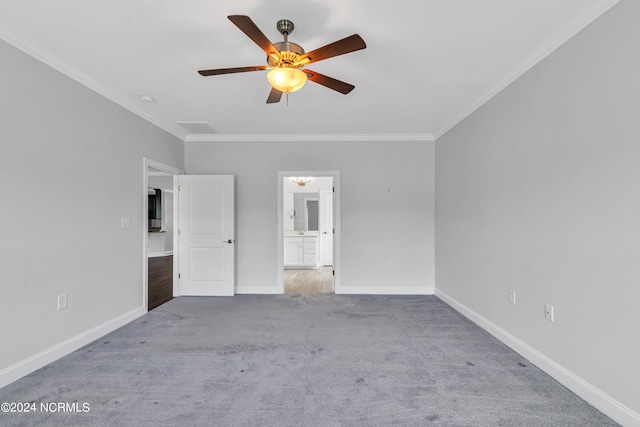 carpeted spare room with crown molding and ceiling fan