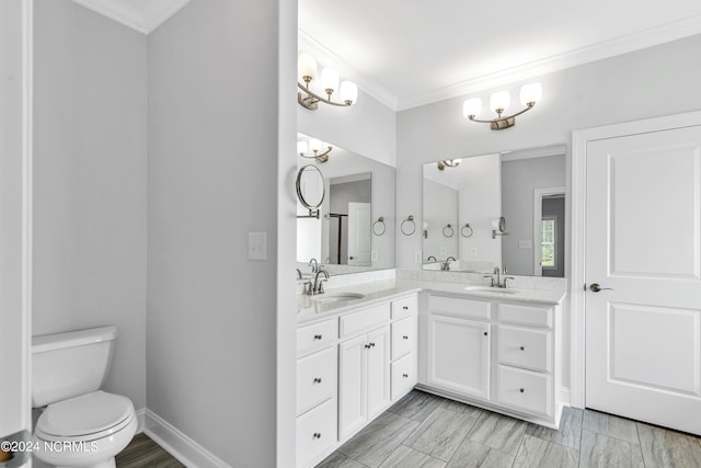 bathroom featuring tile patterned floors, double sink vanity, toilet, and crown molding