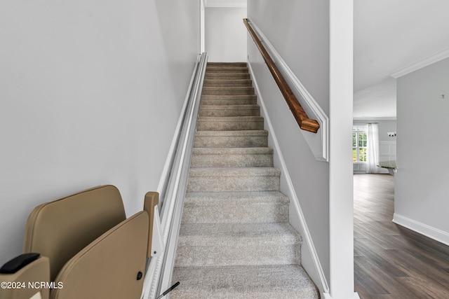 stairs featuring hardwood / wood-style flooring and ornamental molding