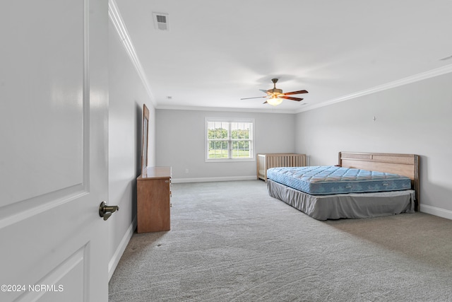 bedroom with ceiling fan, ornamental molding, and carpet floors