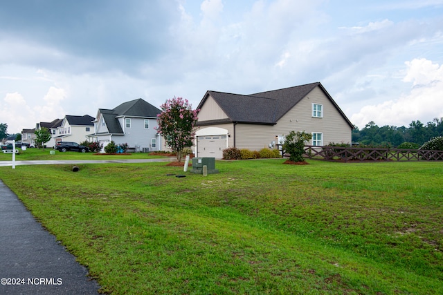 view of side of property featuring a lawn and a garage